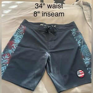 Men's Travis Mathew navy with Hawaiian detail swim trunks.  Waist 34" inseam 8".